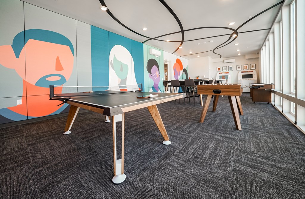a ping pong table in a room with other tables
