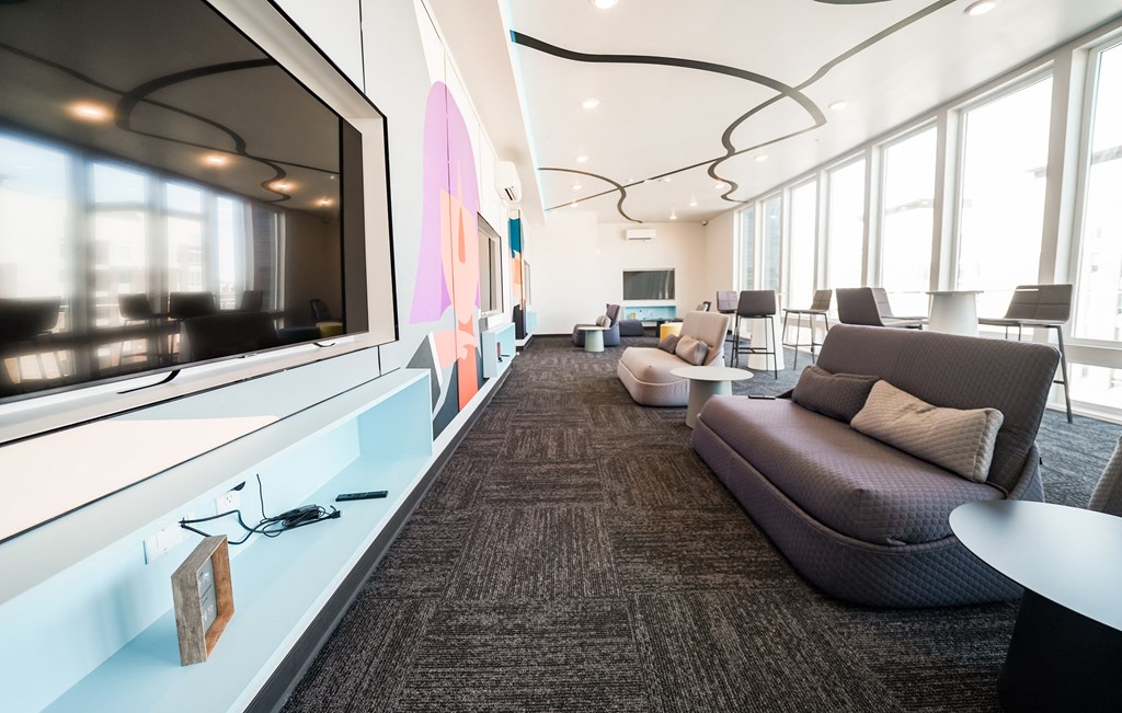 a large room with couches and chairs and a large window