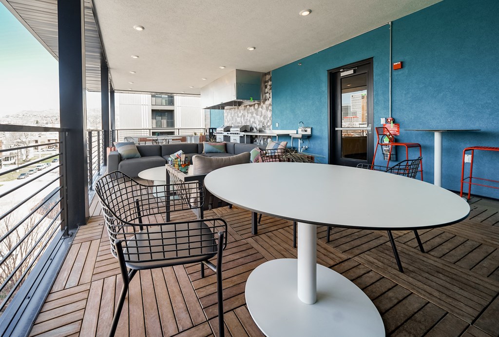 a living room with a table and chairs and a balcony