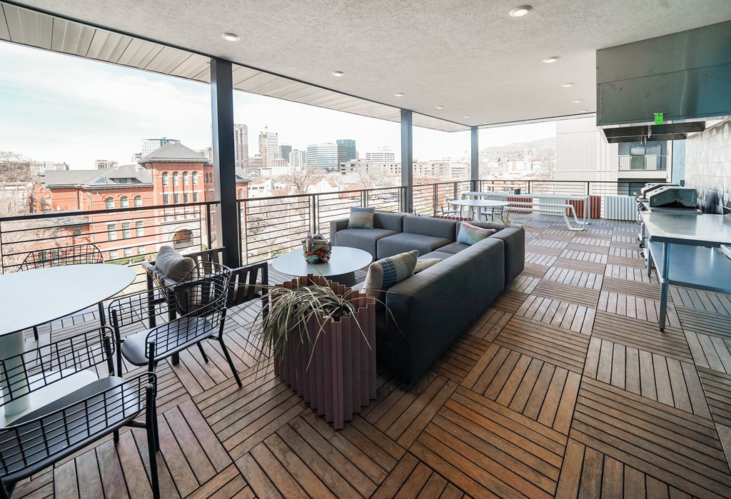 a living room with a couch and a table on a balcony