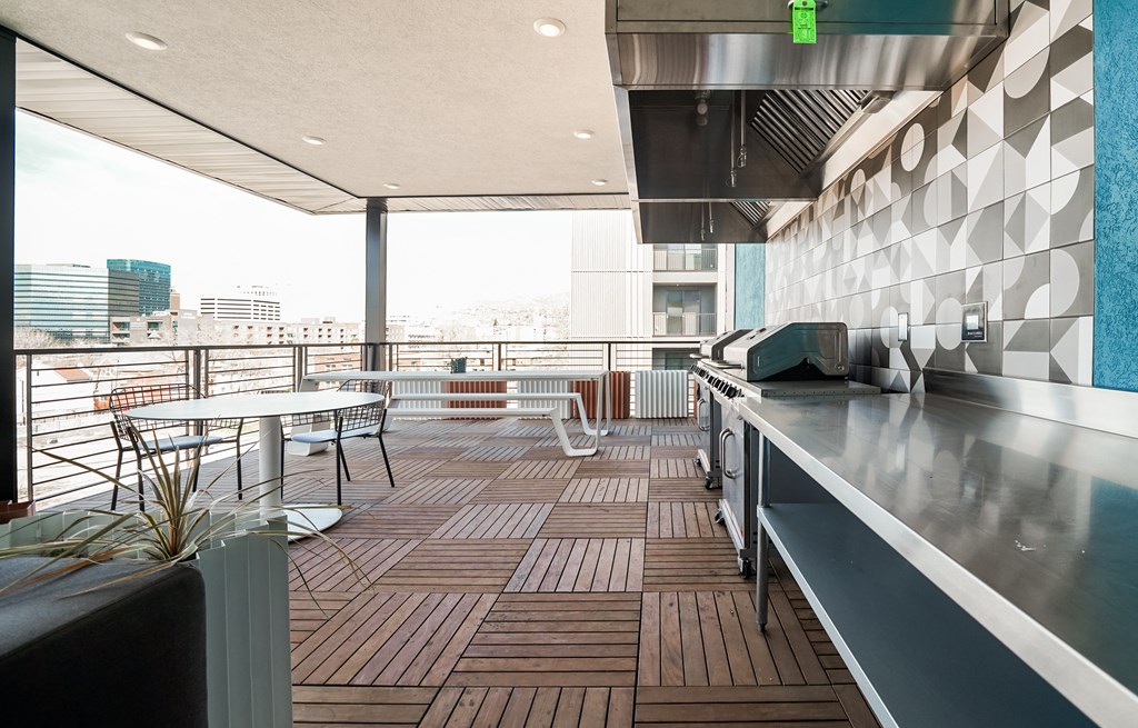a balcony with a table and chairs and a counter