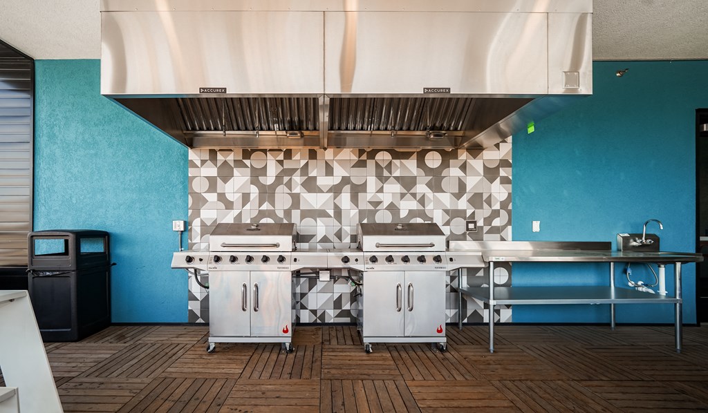 a kitchen with two stoves and a counter with a blue wall