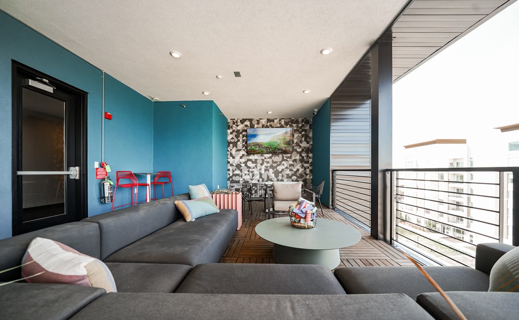 a living room with blue walls and a gray couch and a coffee table