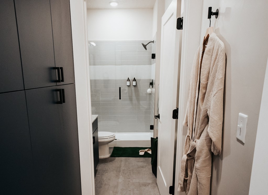 a bathroom with a shower and a towel hanging on the wall