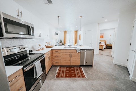 a kitchen with stainless steel appliances and wooden cabinets