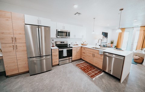 a kitchen with stainless steel appliances and wooden cabinets