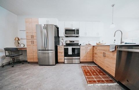a kitchen with wooden cabinets and stainless steel appliances