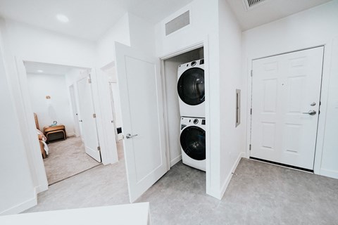 a white laundry room with a washer and dryer in a closet