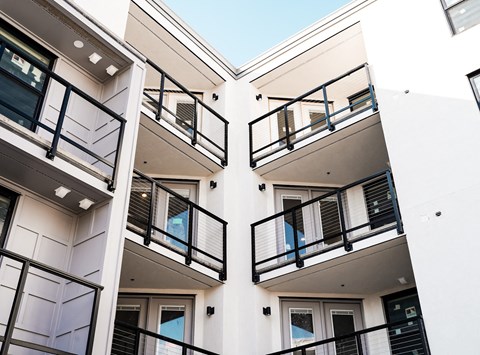a row of balconies on a white apartment building