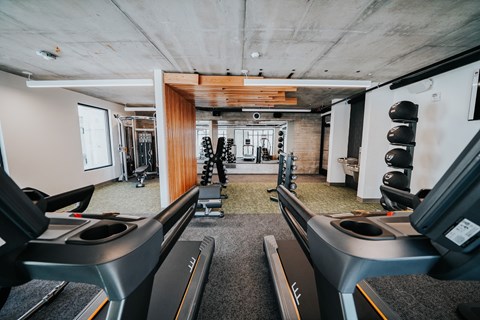a large room with a bunch of desks and a large colorful graphic on the wall