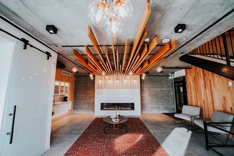 a living room with a fireplace and a chandelier