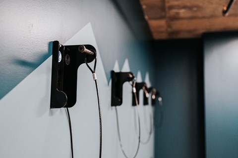 a row of plug in chargers on a wall