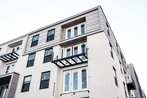 a view of the side of a building with windows and balconies