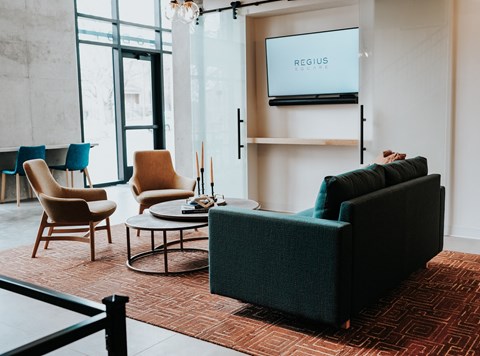 a living room with a couch and chairs and a television