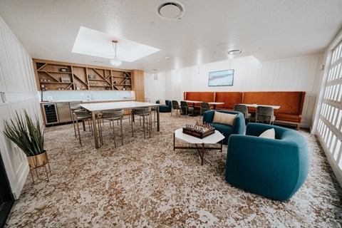 a living room with a table and chairs and a kitchen