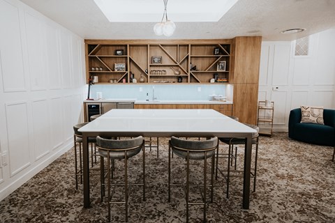 a kitchen with a white table and chairs