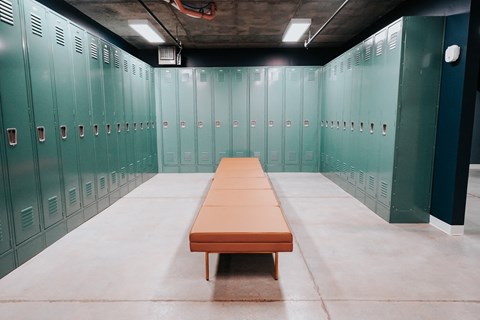 a row of lockers and a bench in a locker room
