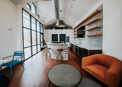 a living area with a kitchen and a couch and a table