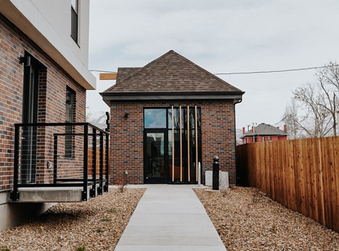 the front entrance of a brick house with a glass door
