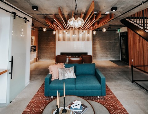 a living room with a blue couch and a fireplace