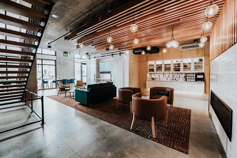 a lobby with couches and chairs and a staircase