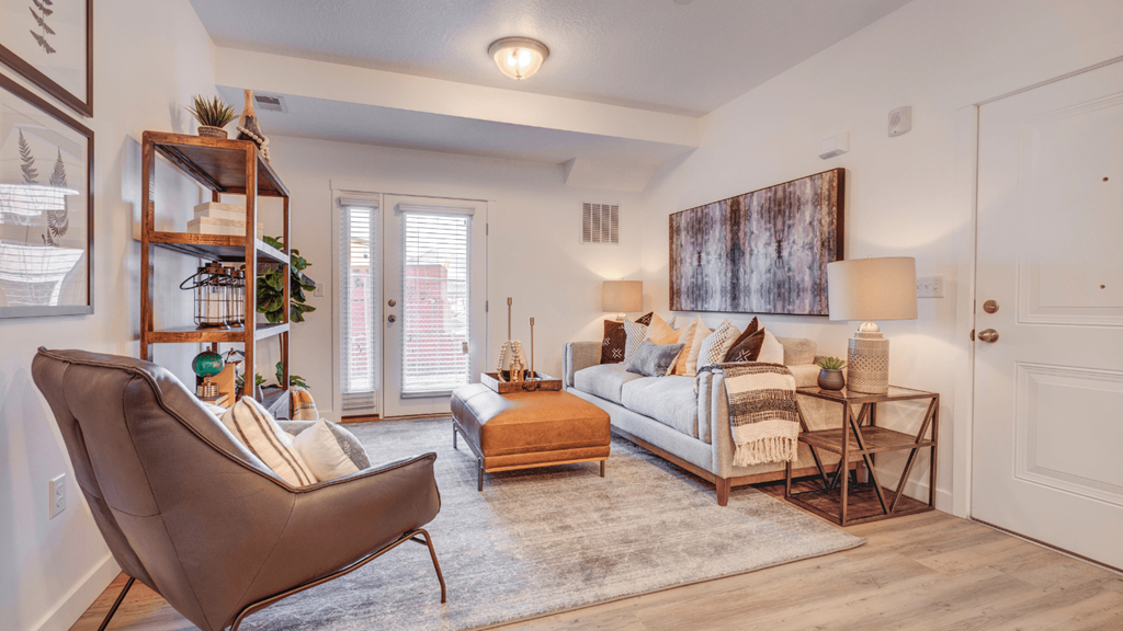 A living room with a brown chair and a white couch.