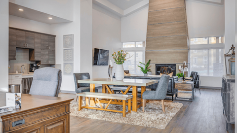 A modern dining room with a wooden table and chairs.