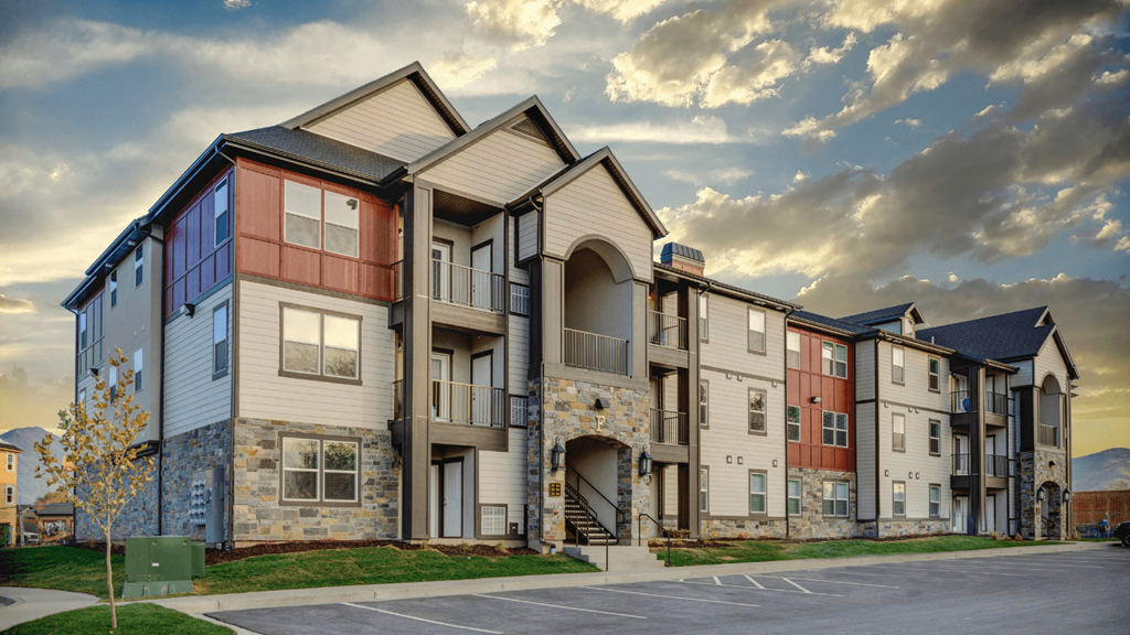 Apartment complex with a mix of beige, brown, and blue exterior colors.