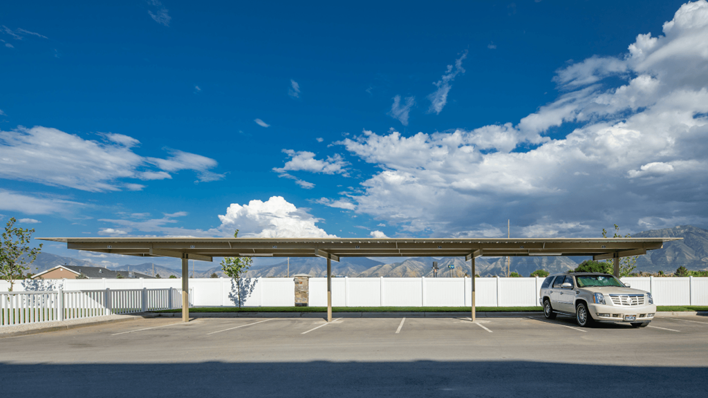 A parking lot with a car parked under a canopy.