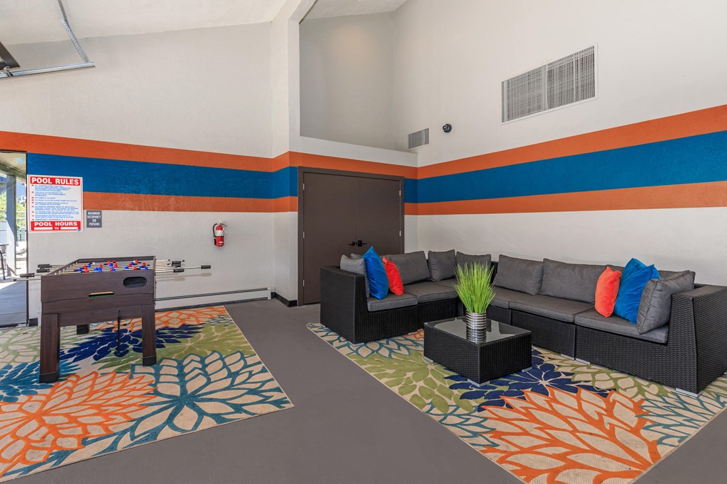 A living room with a grey couch and a wooden table.