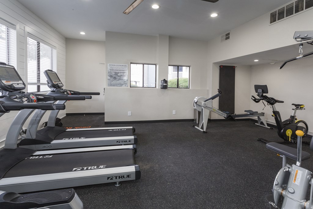 a gym with treadmills and other exercise equipment in a building
