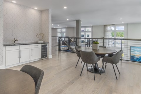 A dining room with a table and chairs.