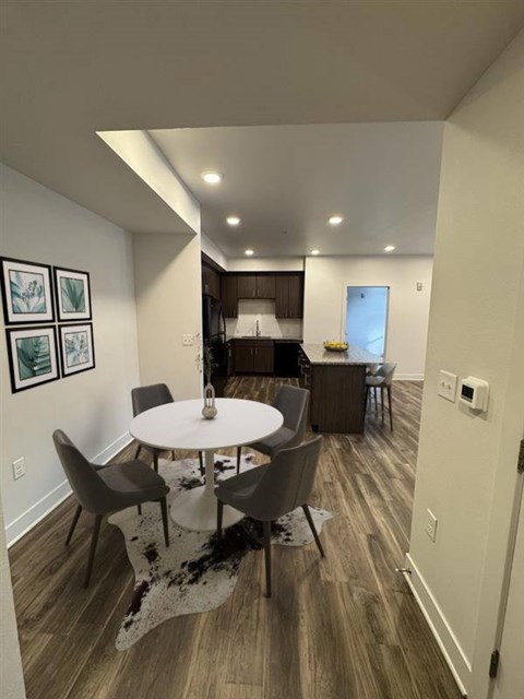 A dining room with a white table and chairs.