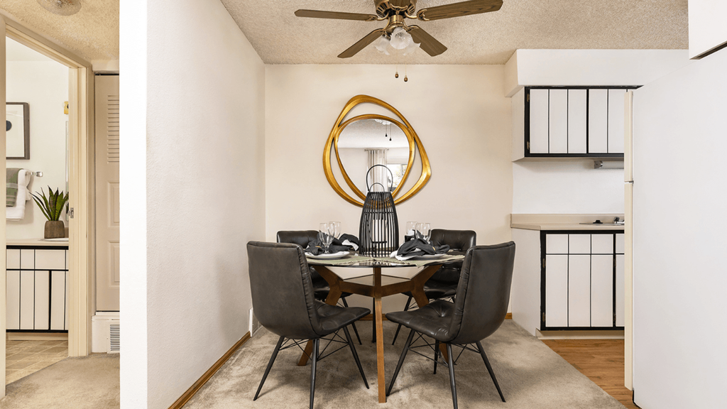 a dining room with a table and chairs and a ceiling fan