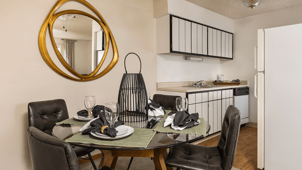 a dining room with a table and chairs and a kitchen