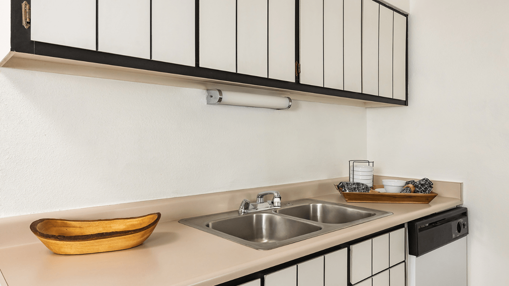 a kitchen with a sink and a window above it