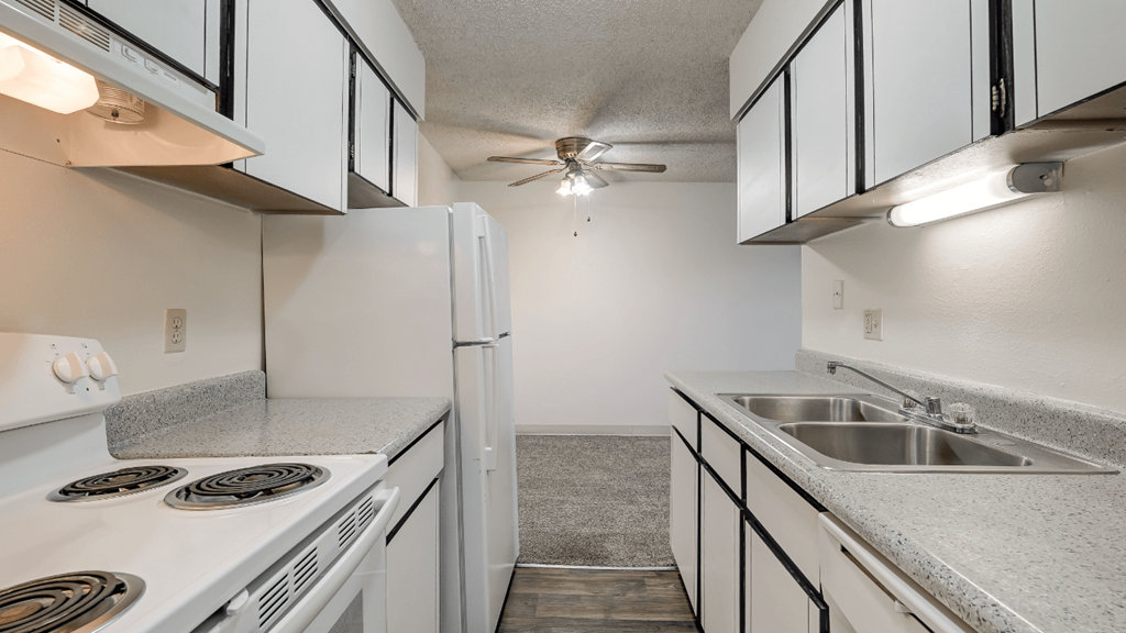 the kitchen of our studio apartment atrium with white appliances and granite countertops
