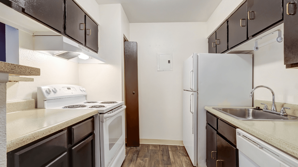 a kitchen with white appliances and a white refrigerator