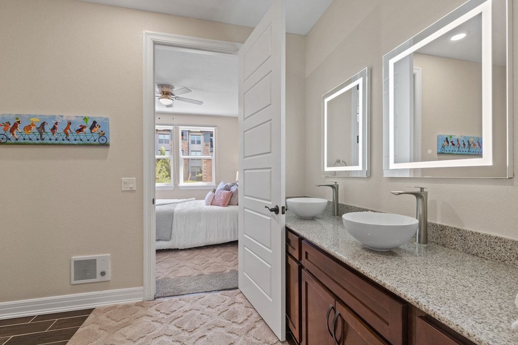 a bathroom with a sink and a doorway to a bedroom
