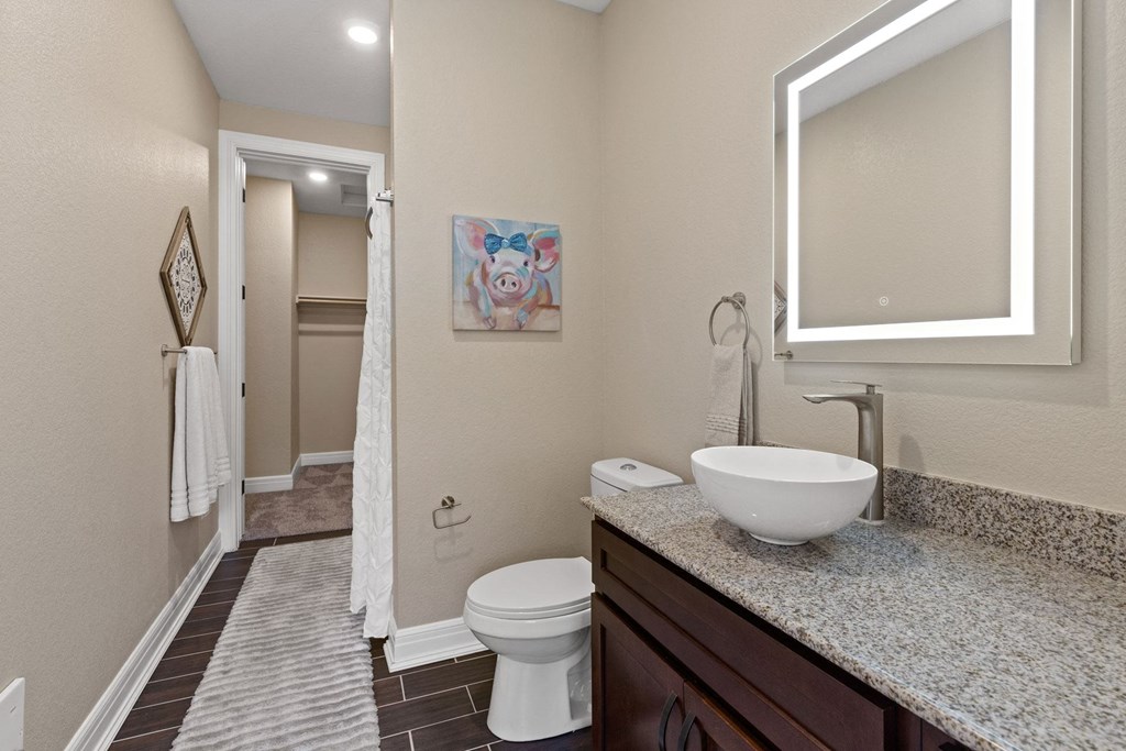 a bathroom with a sink and a toilet and a shower