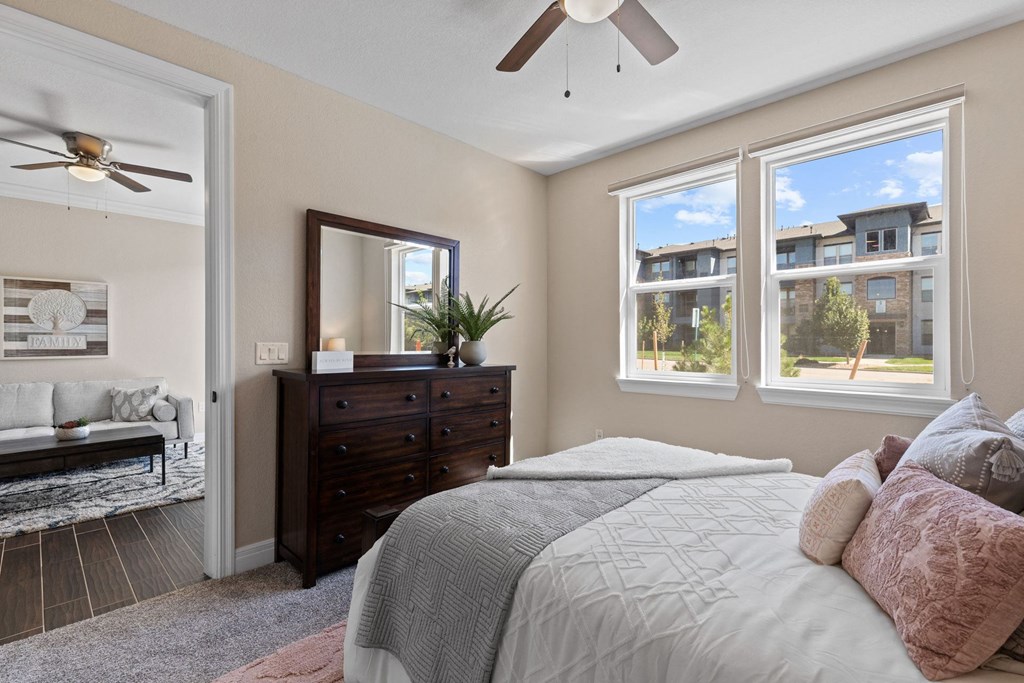 a bedroom with a large bed and a ceiling fan