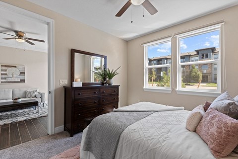 a bedroom with a large bed and a ceiling fan