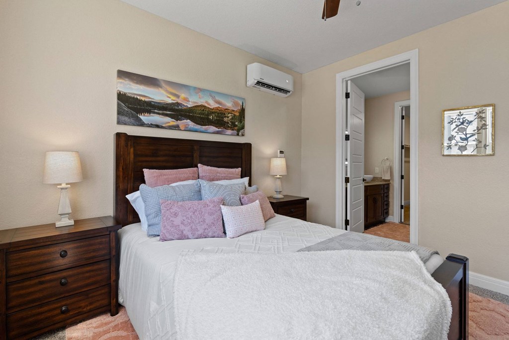 a bedroom with a large bed and a painting on the wall