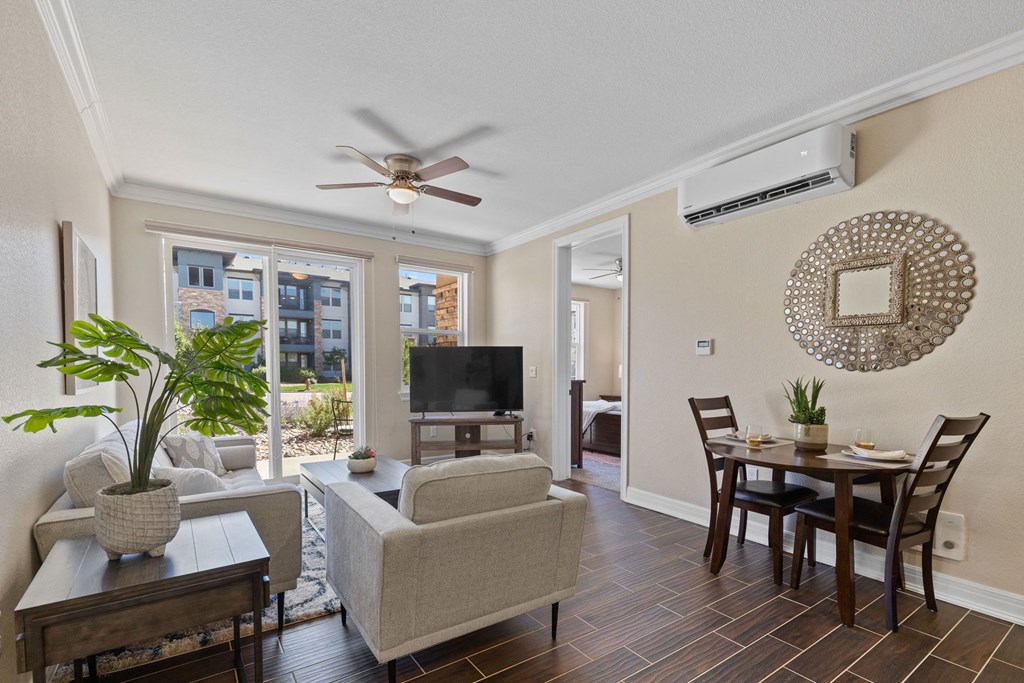 an open living room and dining room with a ceiling fan