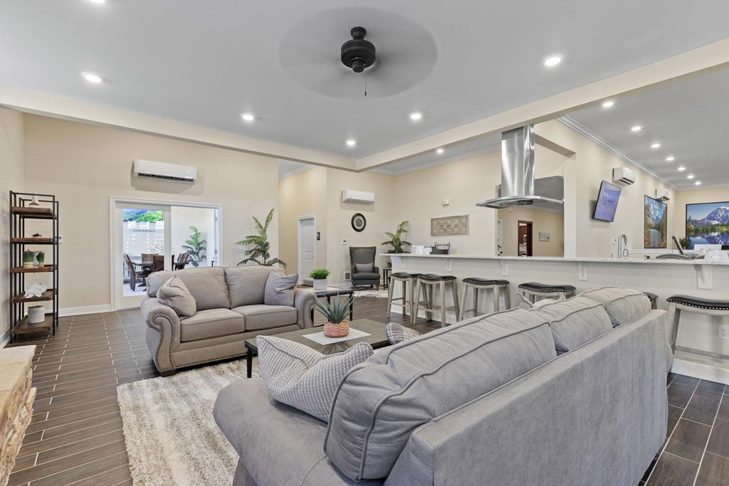 a large living room with couches and a kitchen