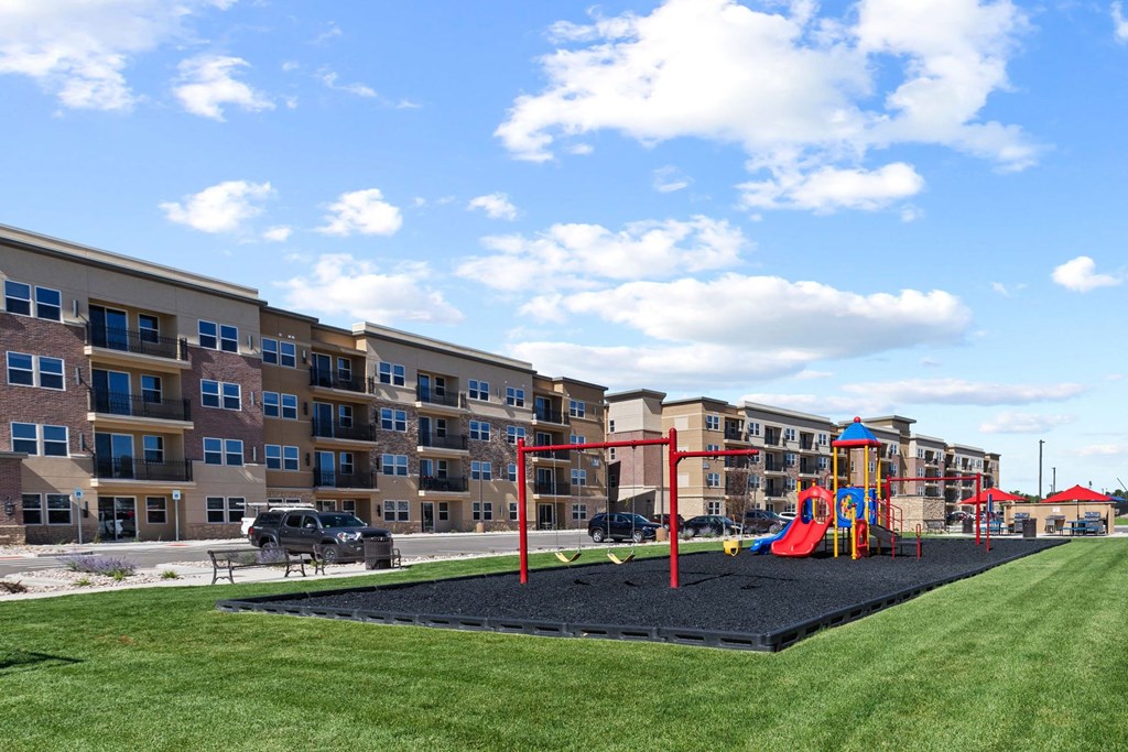a playground in front of an apartment building