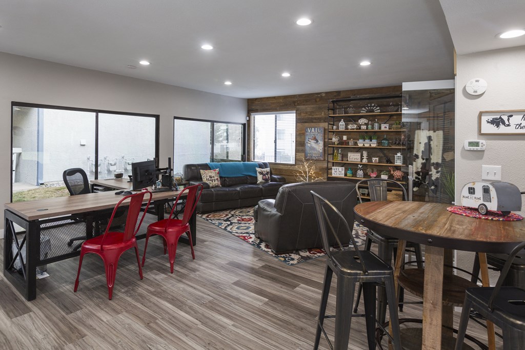 a living room and dining room with a table and chairs