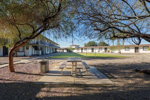 A picnic table is in the middle of a courtyard.
