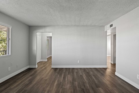 A room with wooden floors and white walls.