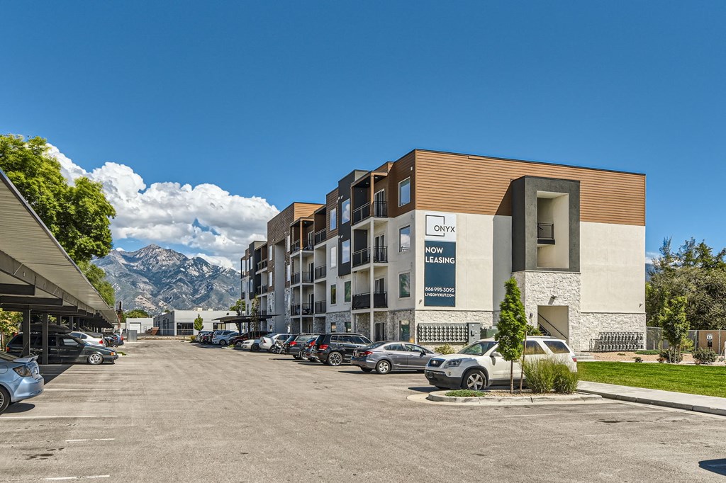 a building with cars parked in front of it on a street